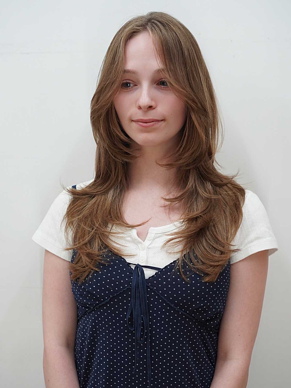 Long sandy blonde hair with soft face-framing layers