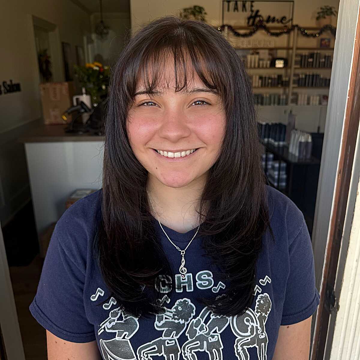 Shoulder-length dark shag with wispy bangs and layers