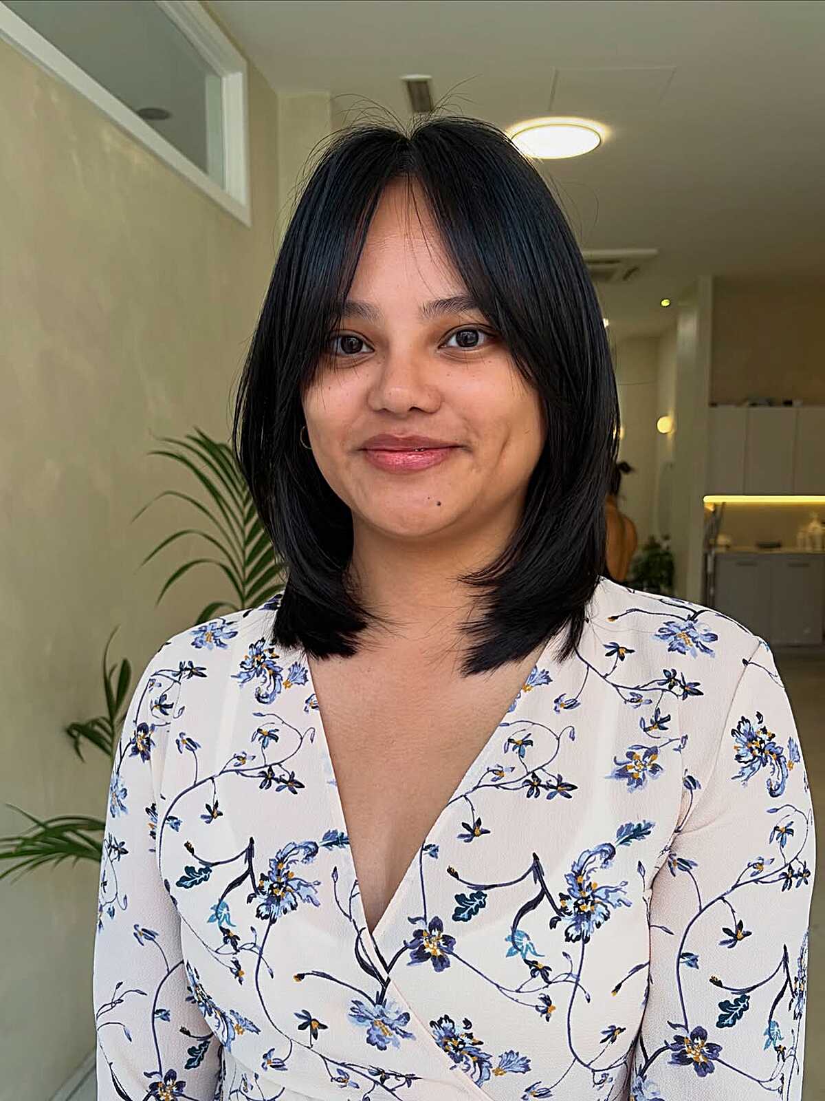Black shoulder-length lob with side-parted wispy bangs