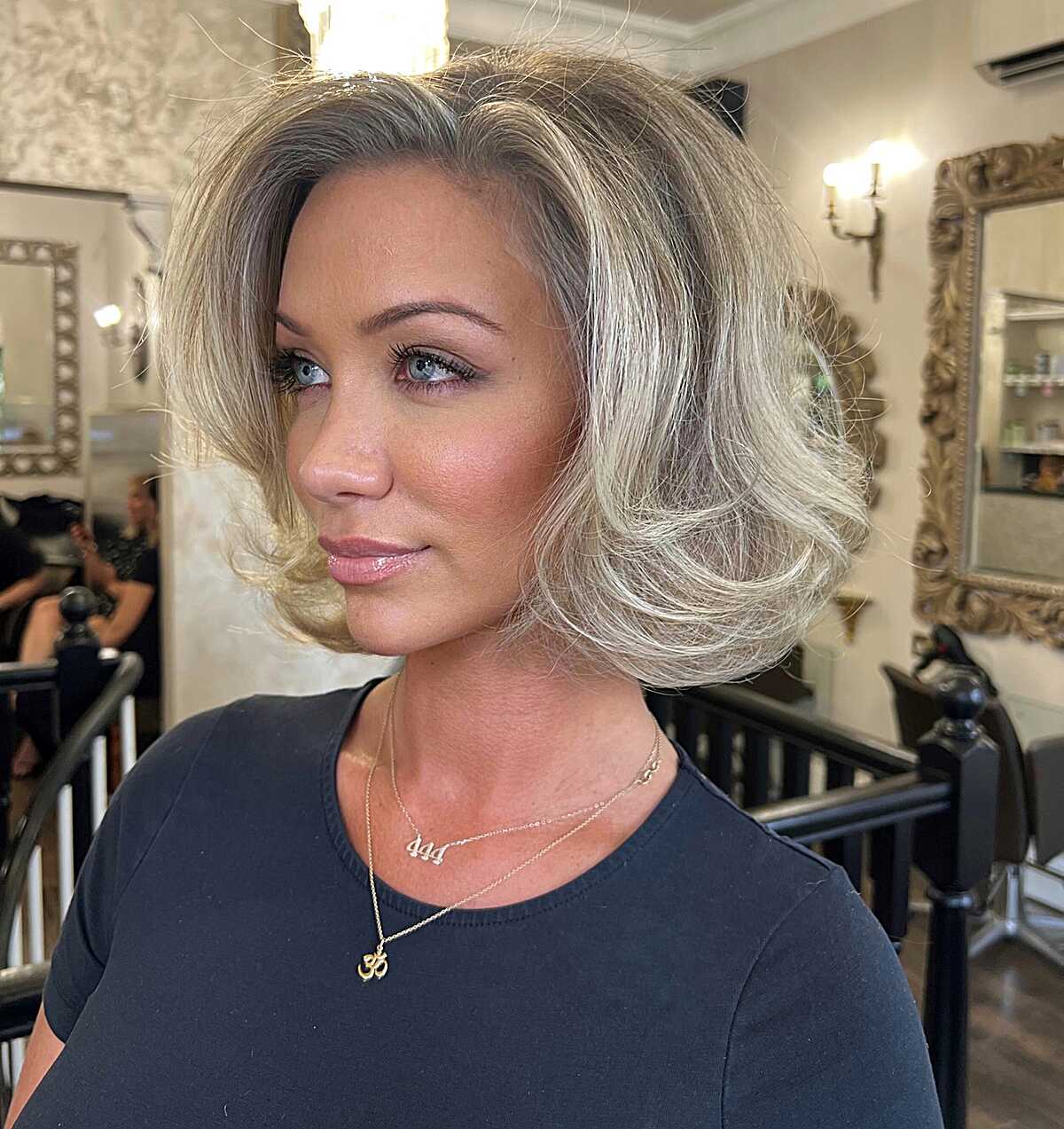 Silver blonde bob with dramatic volume and swooping waves
