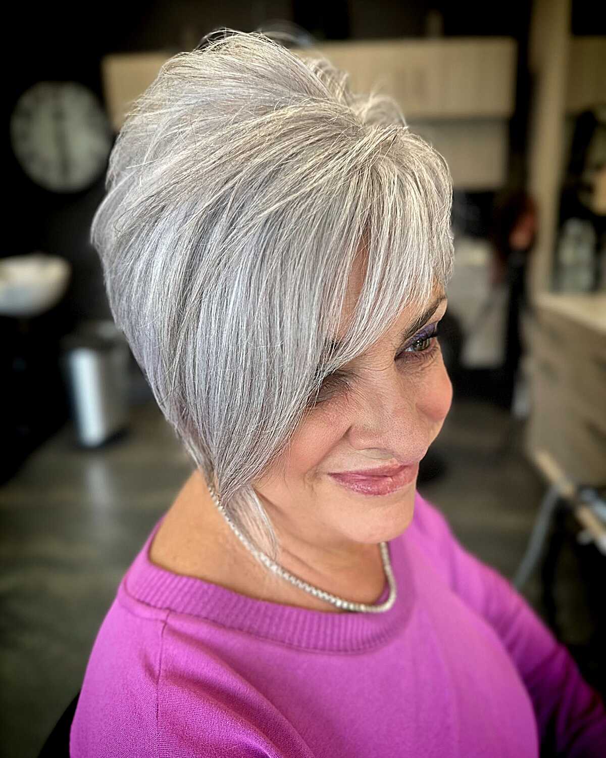 Silver bixie with long sweeping side layers on older woman