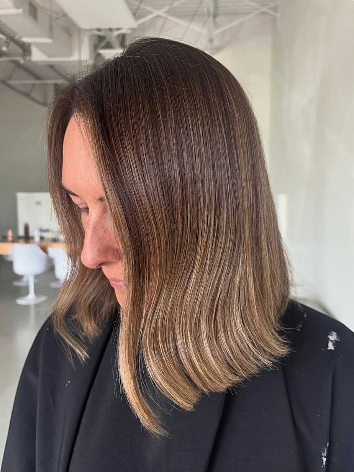 Brunette collarbone-length lob with soft balayage ends