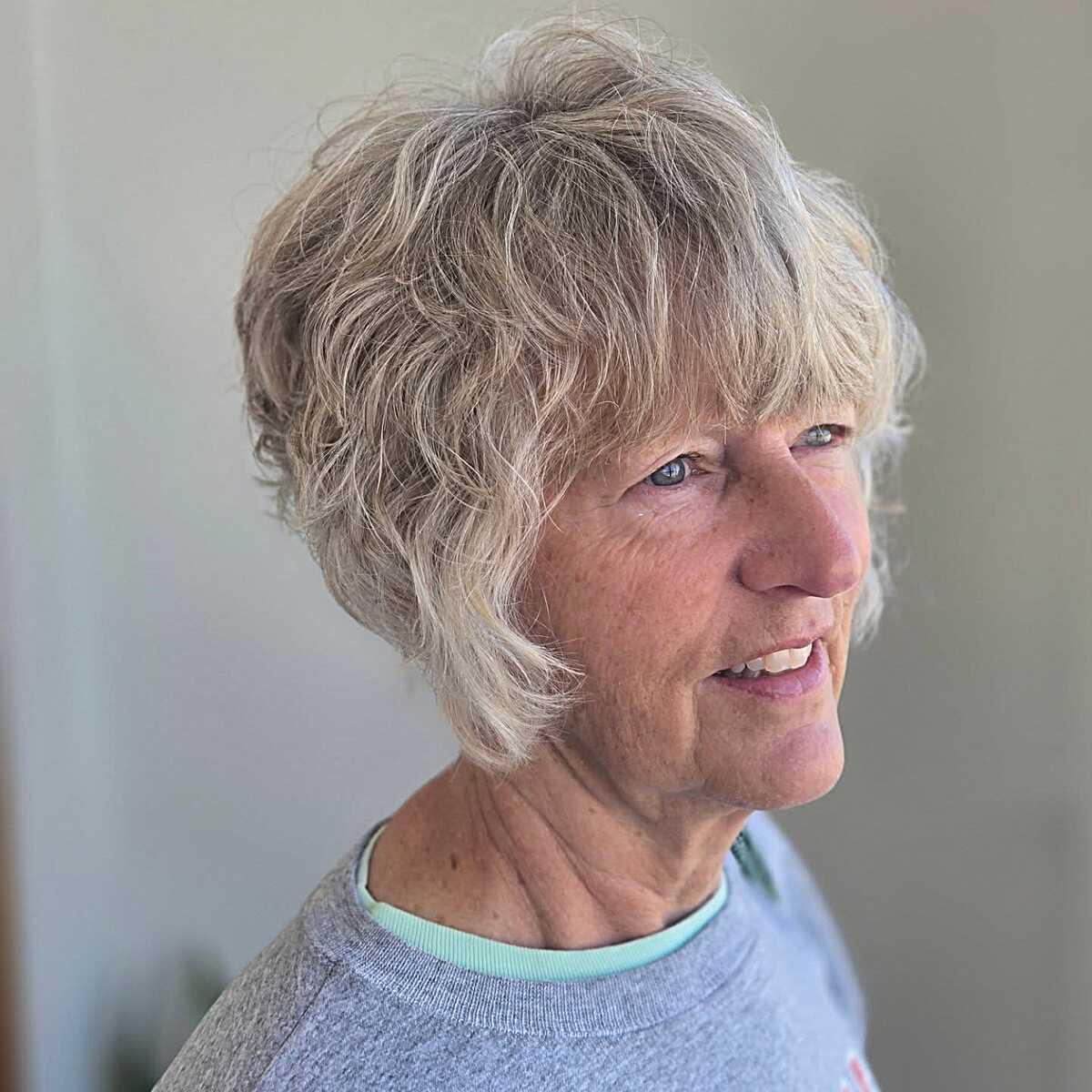 Tousled wavy blonde bixie on older woman with natural texture