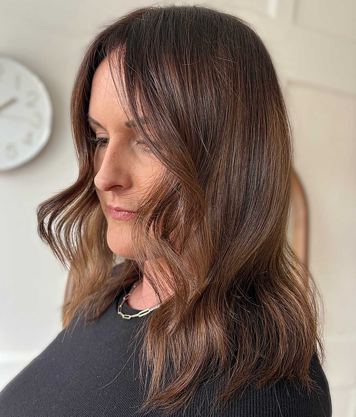 Medium-length chestnut brown hair with subtle warm highlights