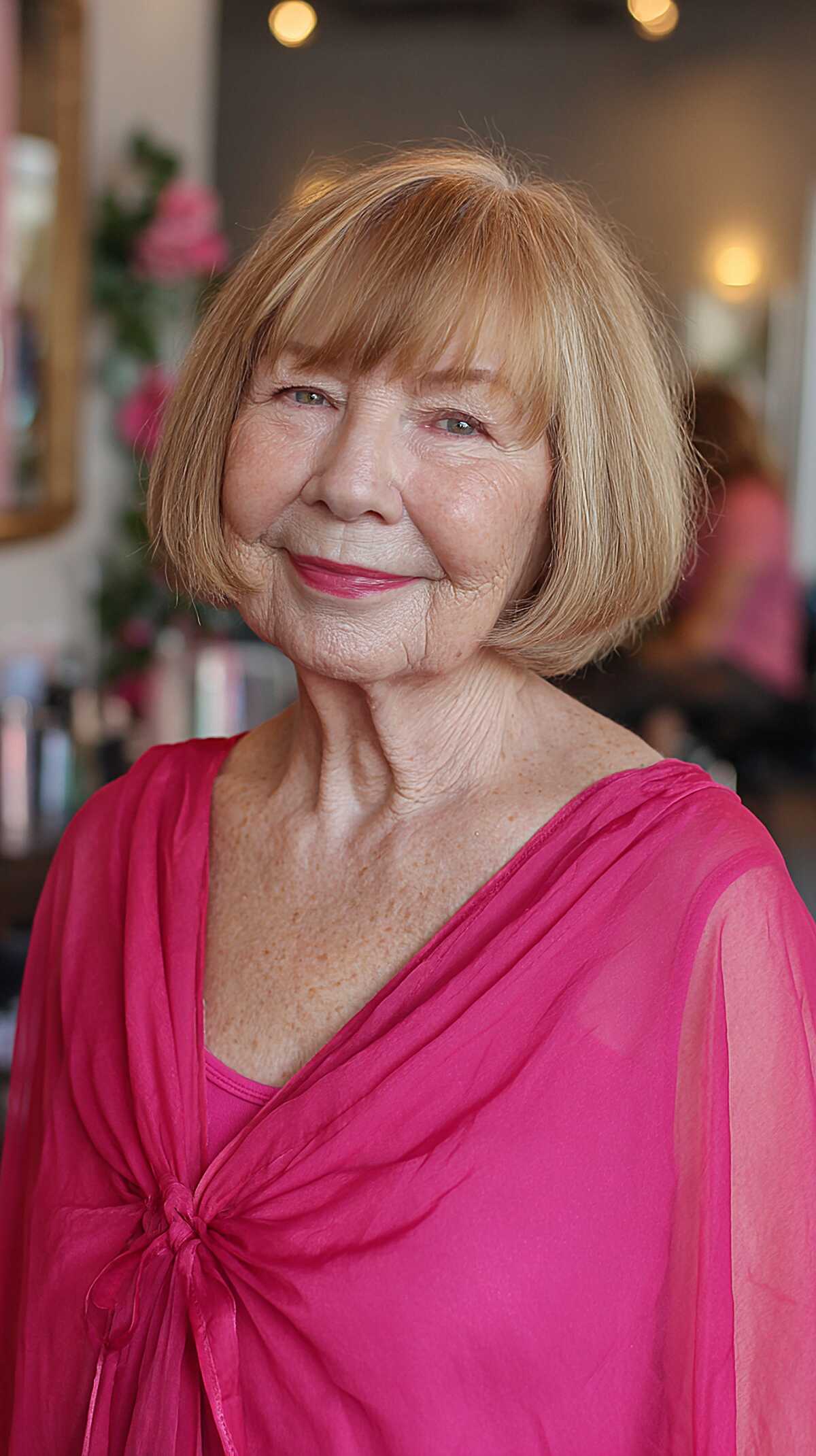 Classic chin-length honey blonde bob with bangs