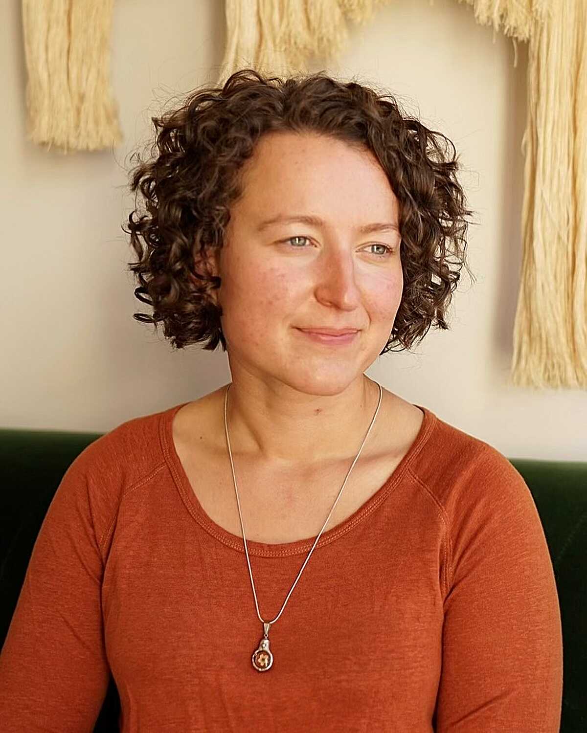 Short cropped curly bob in warm brown with soft shape