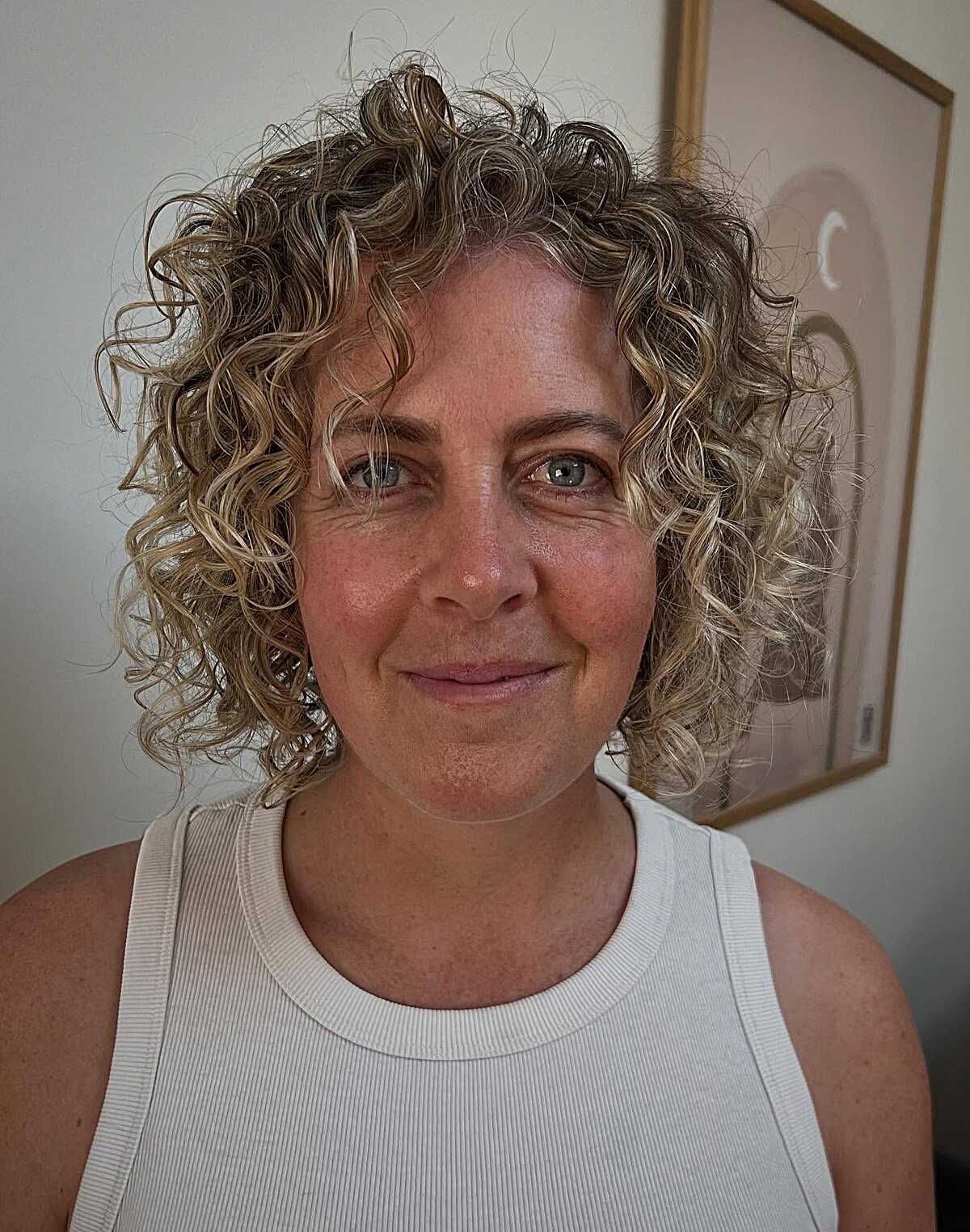 Loose curly bob with sandy blonde and gray blending
