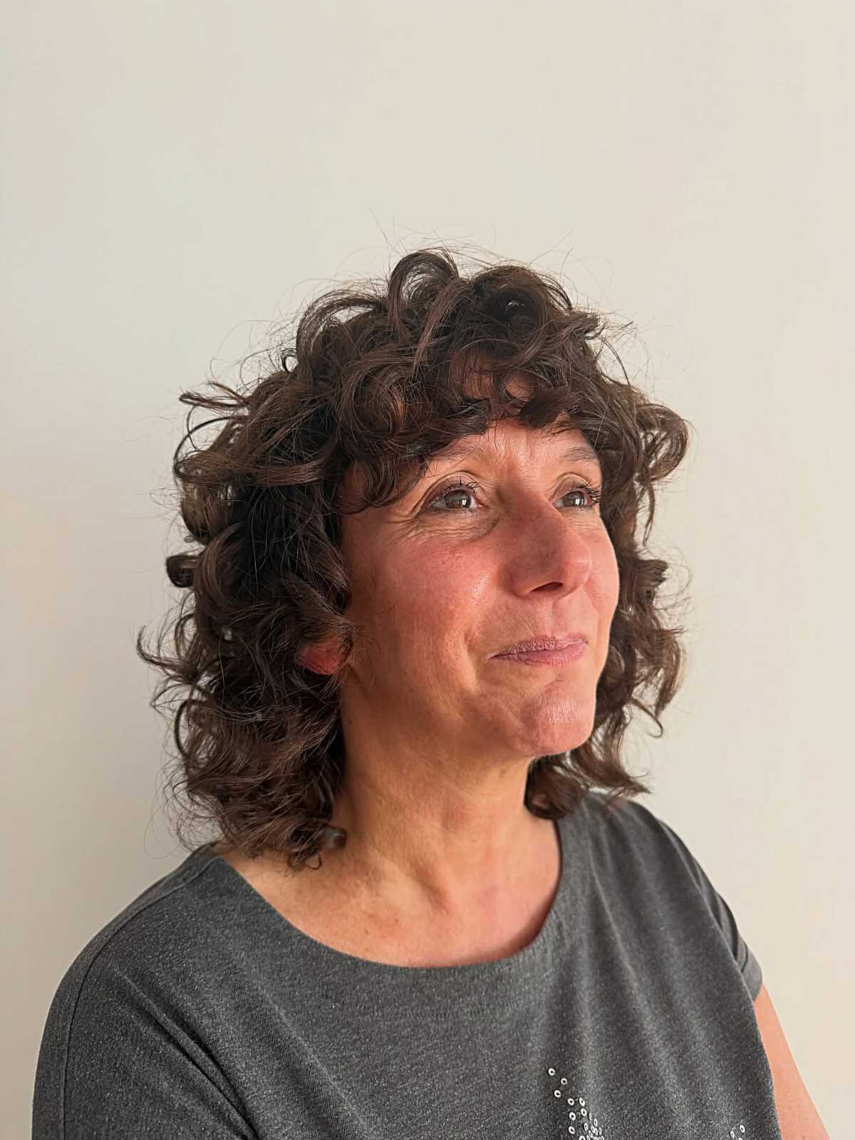 Dark brunette curly shag bob with volume at the crown