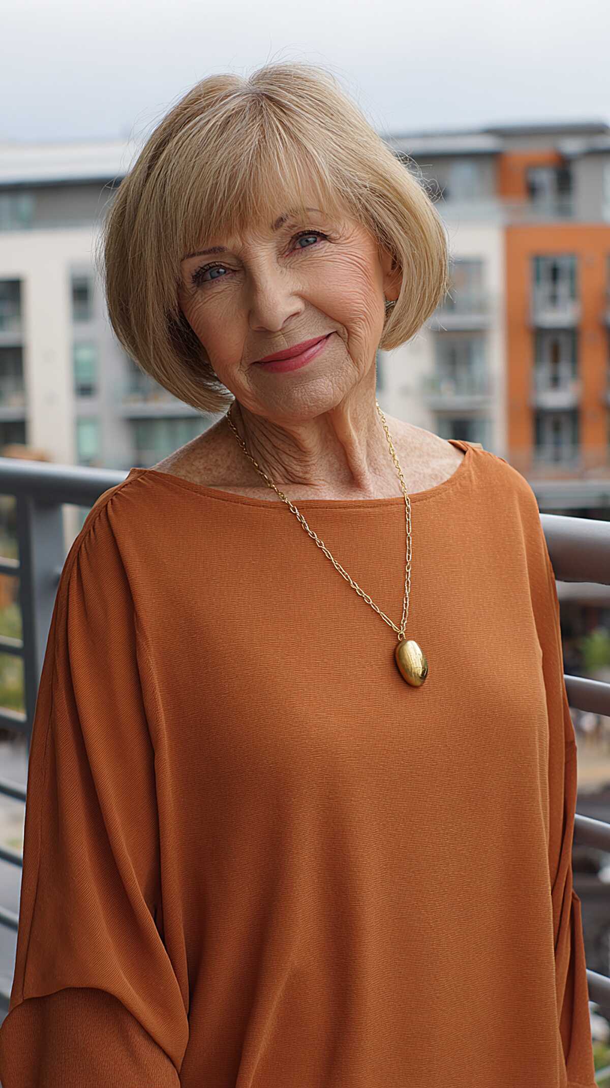 Rounded warm blonde bob with side-swept bangs