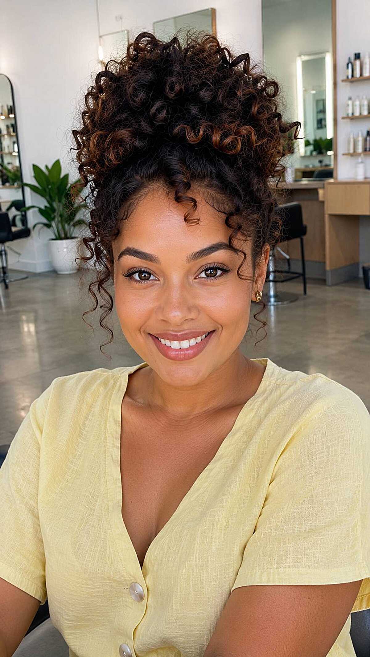 Natural curly hair in a high pineapple updo