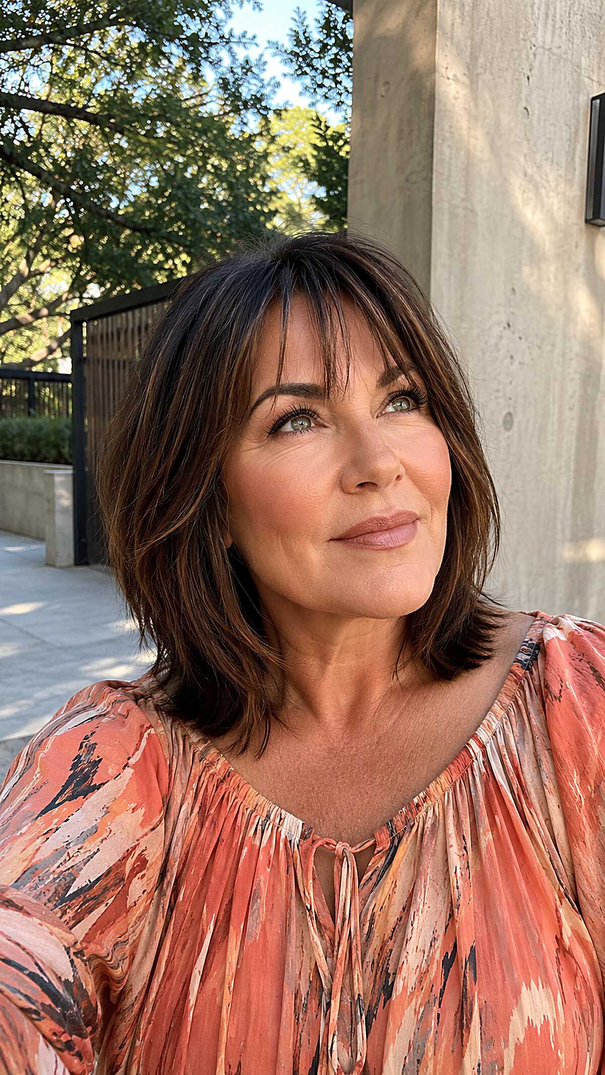Dark brunette textured lob with soft wispy bangs