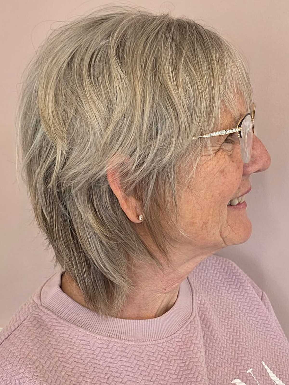 Short feathered gray shag with glasses, side view