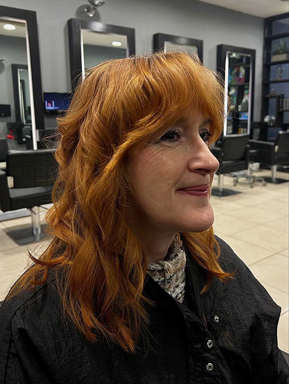 Bright copper red shag with curtain bangs and waves