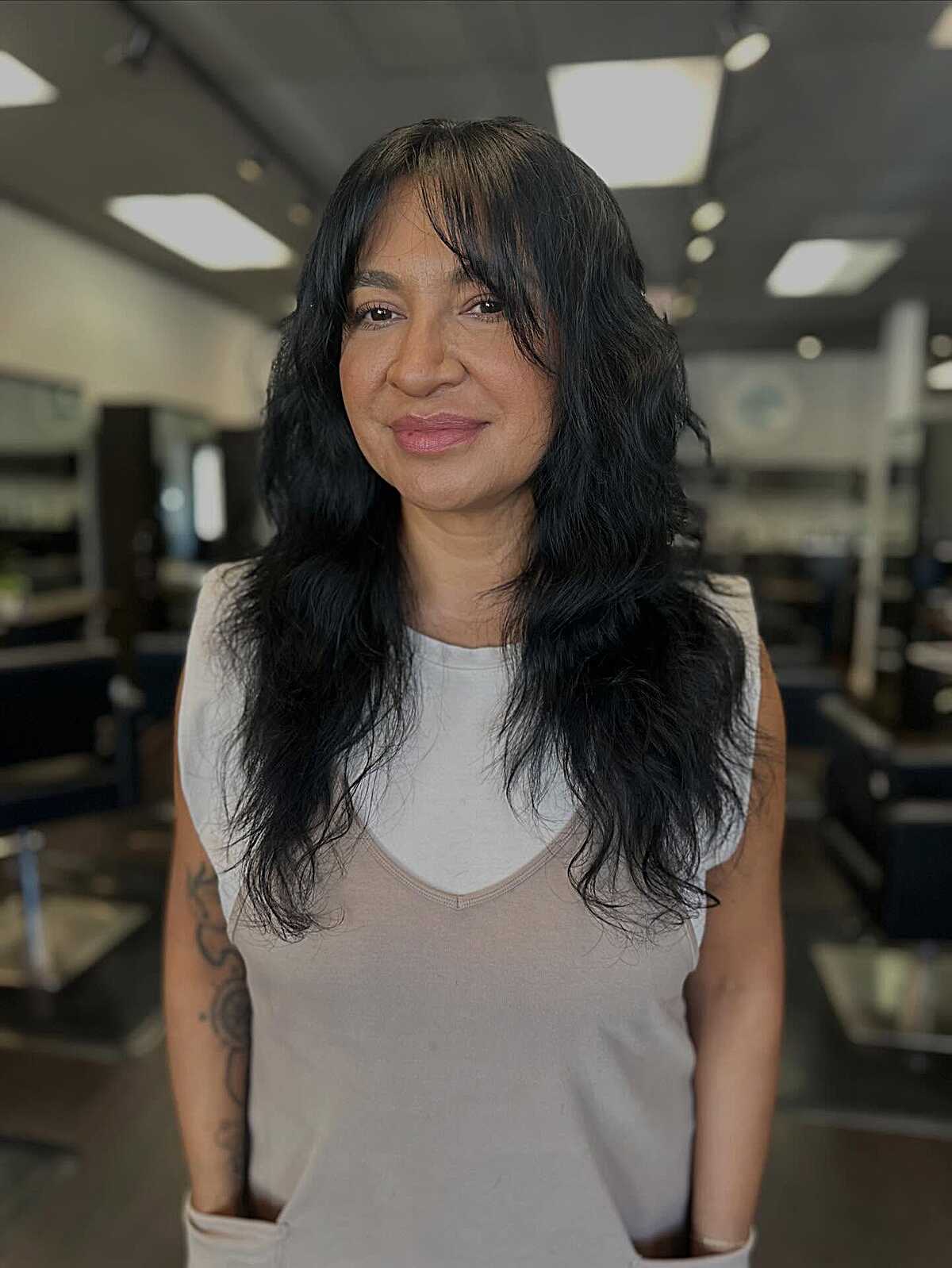 Long black wavy shag with soft face-framing bangs