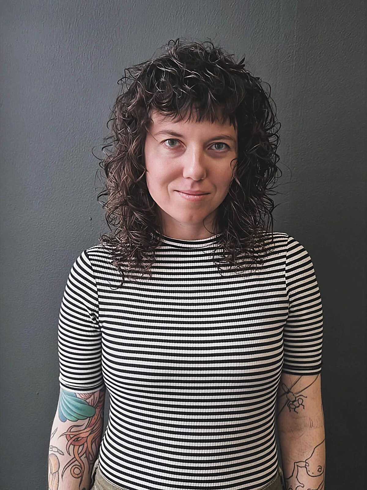 Tight spiral curly shag with center part