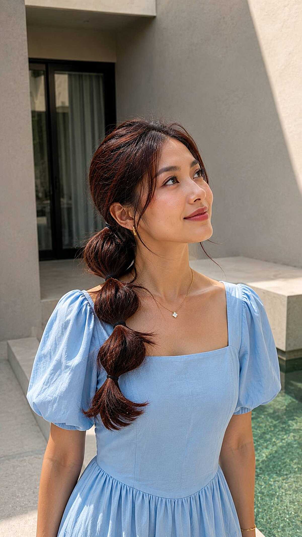 Auburn bubble ponytail with soft curtain bangs