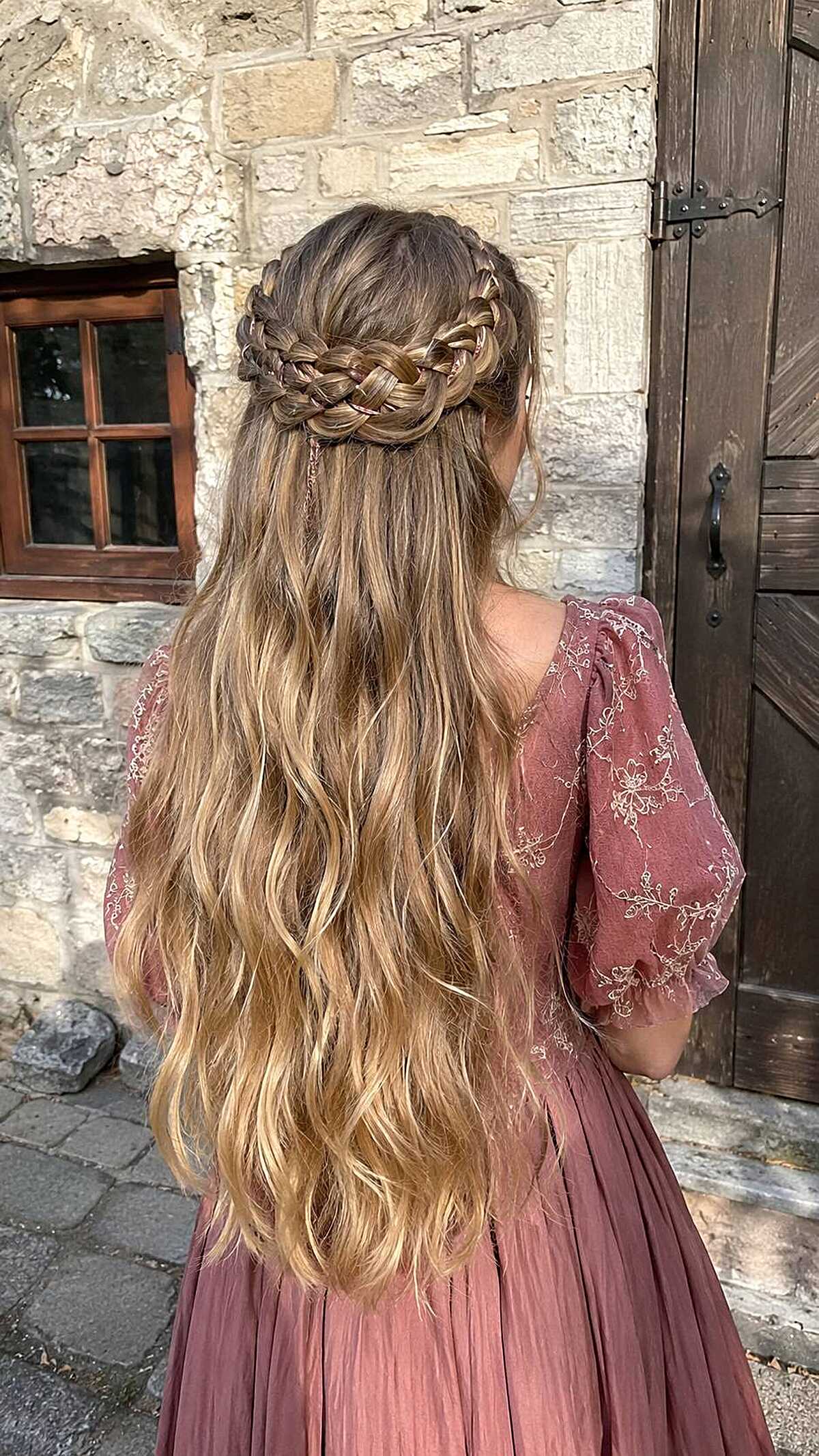 Blonde stacked Dutch braid crown with long wavy hair