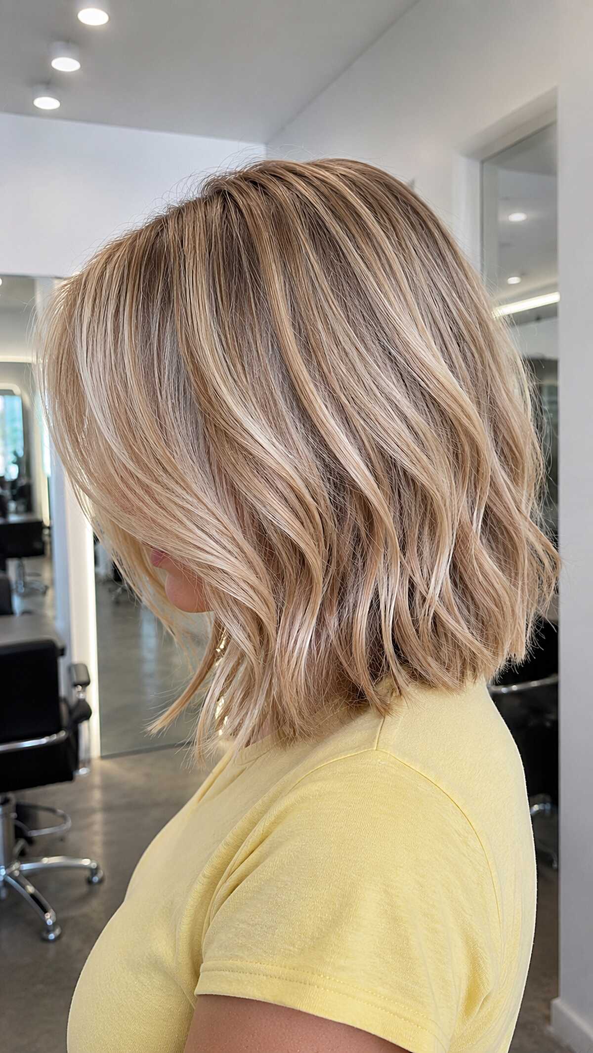 Wavy lob in creamy blonde with soft rose undertone