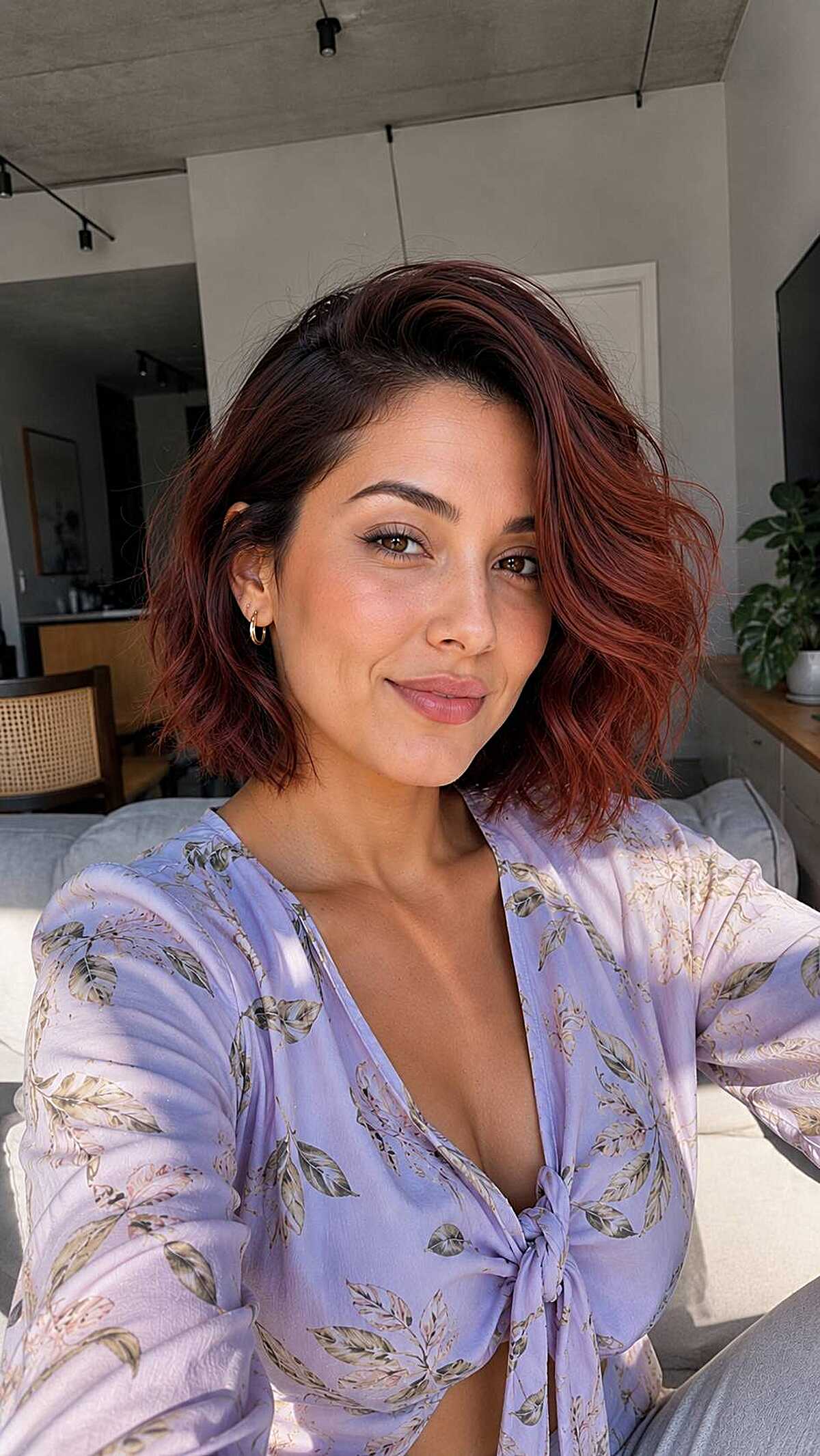 Short wavy bob in cherry cola color with a side part