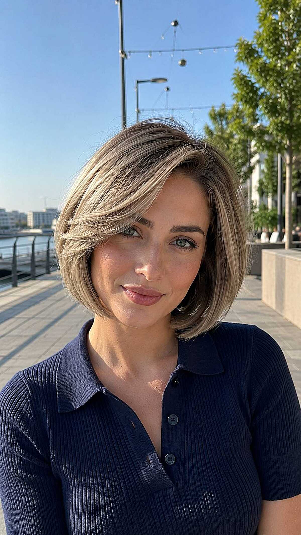 Polished ash blonde bob with a swooping side part