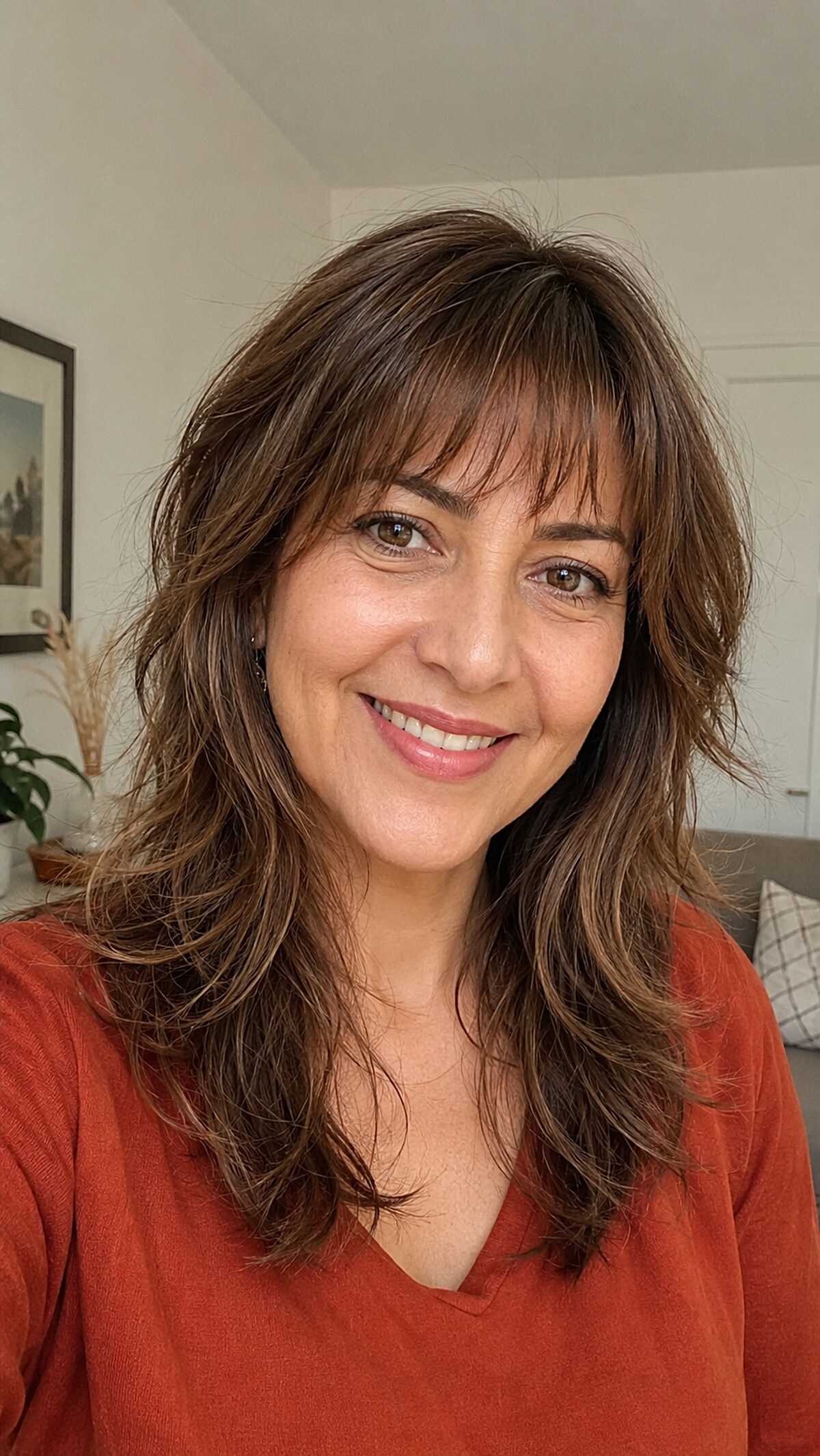 Layered Brunette Wolf with Brow-Skimming Fringe and Flicked Ends