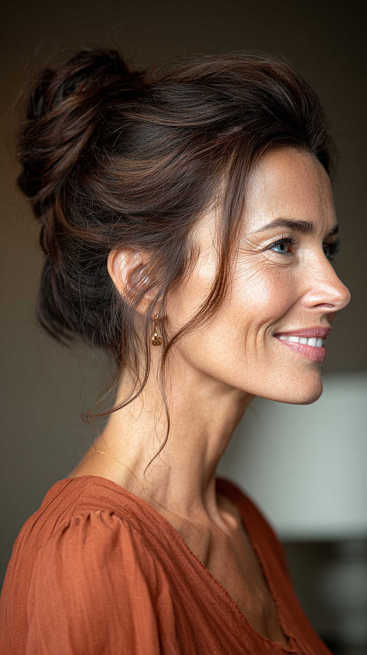 Swept-up dark brunette messy bun with loose nape