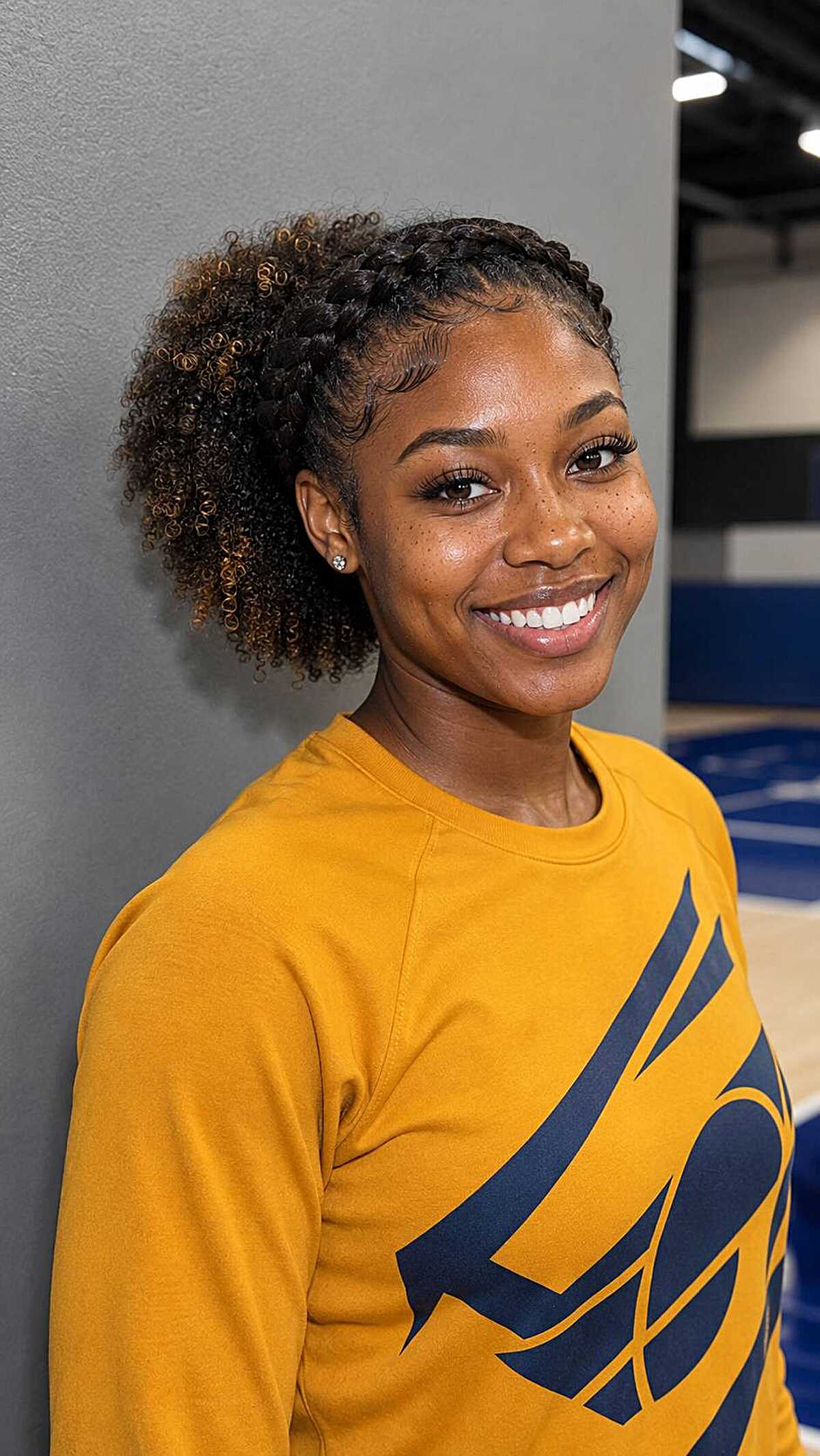 Flat braids in front leading to a curly puff in back
