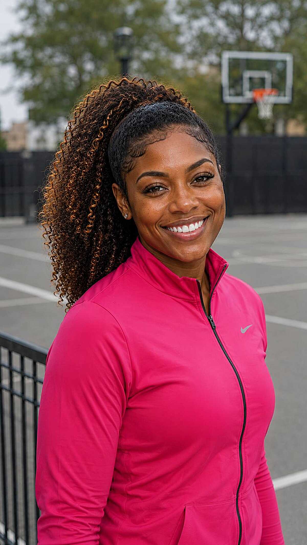 Sleek curly ponytail with black to honey ombré