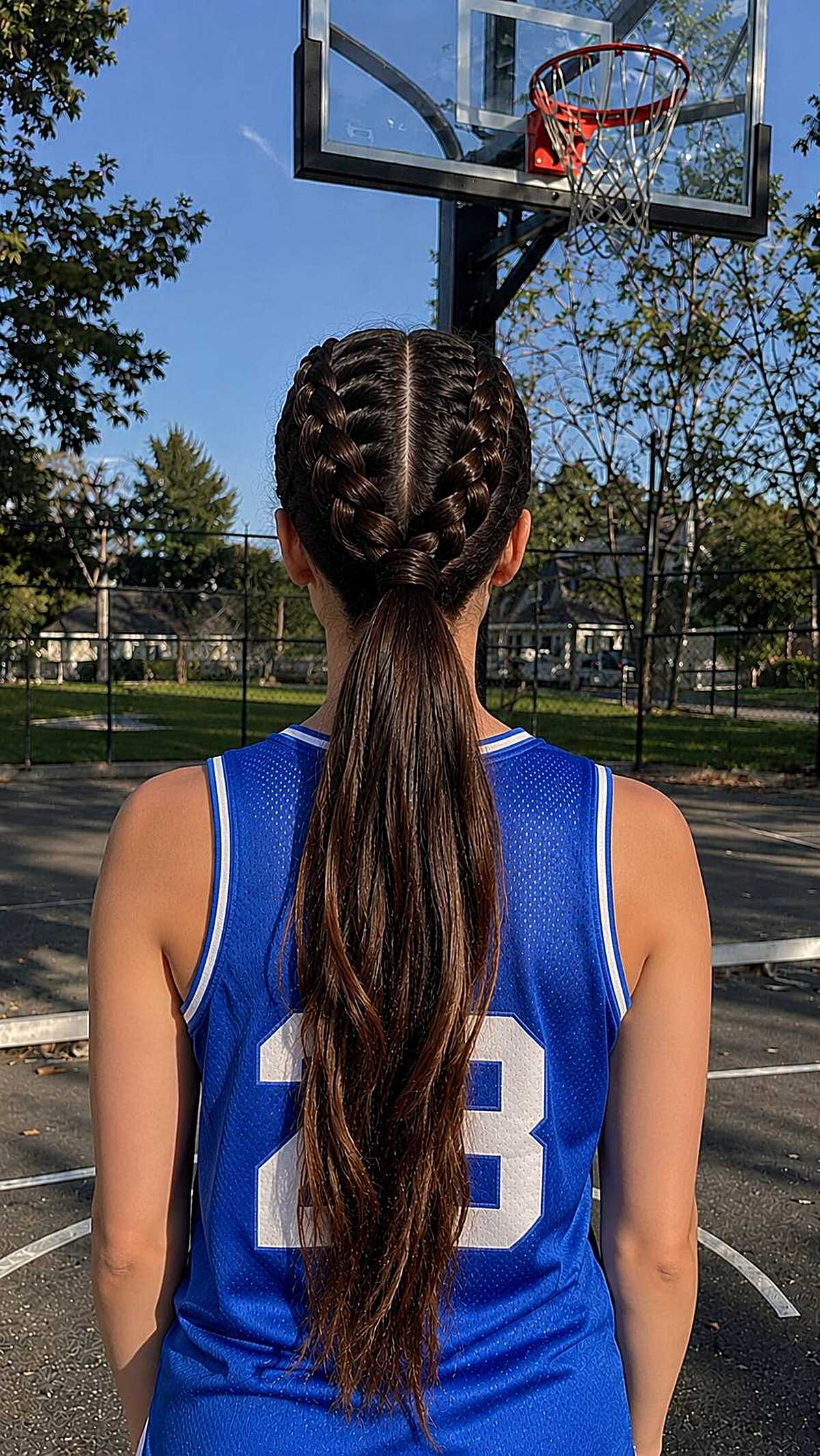 Double French braids merging into a long low ponytail