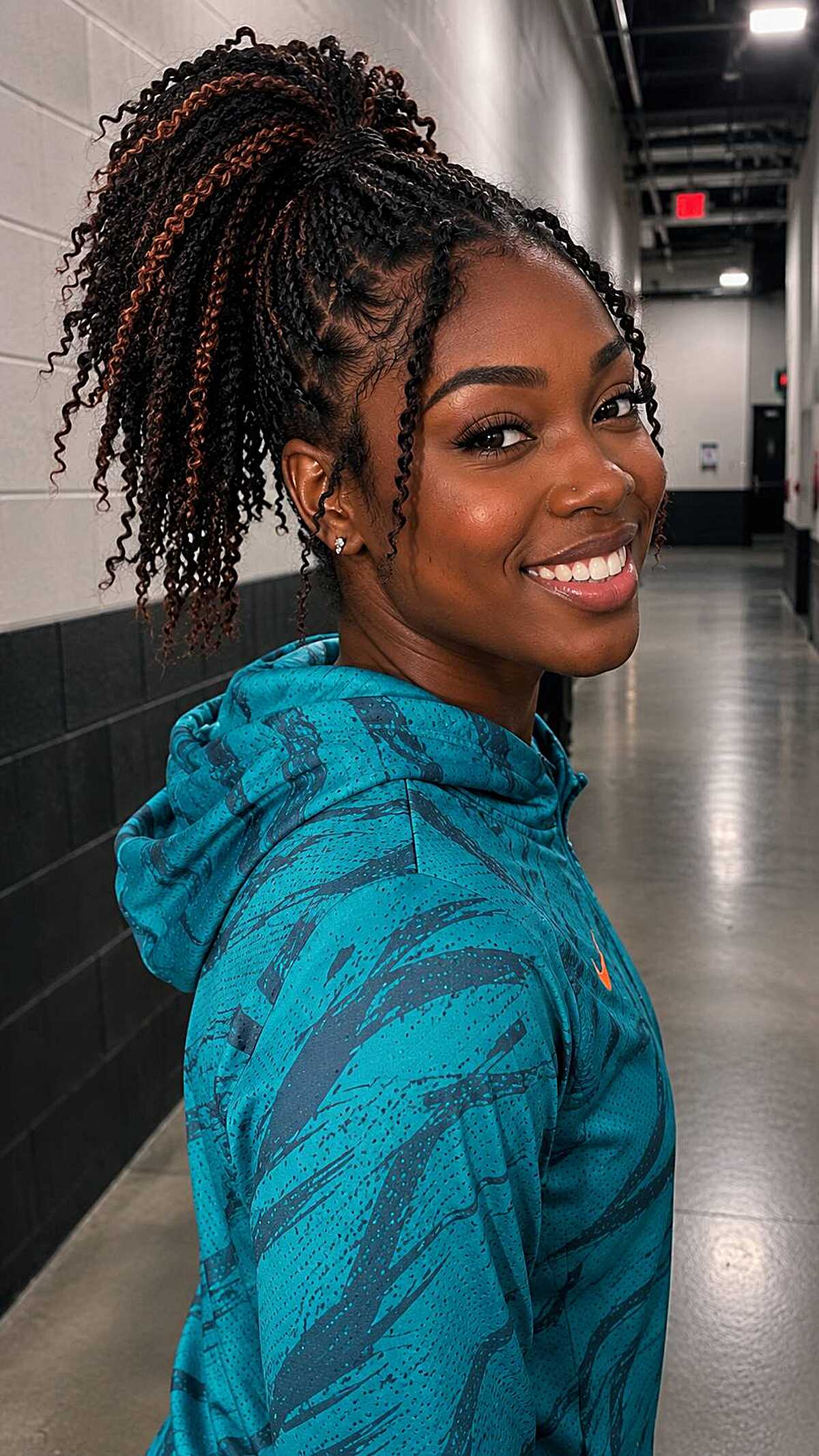 High ponytail of twists with auburn and copper tones