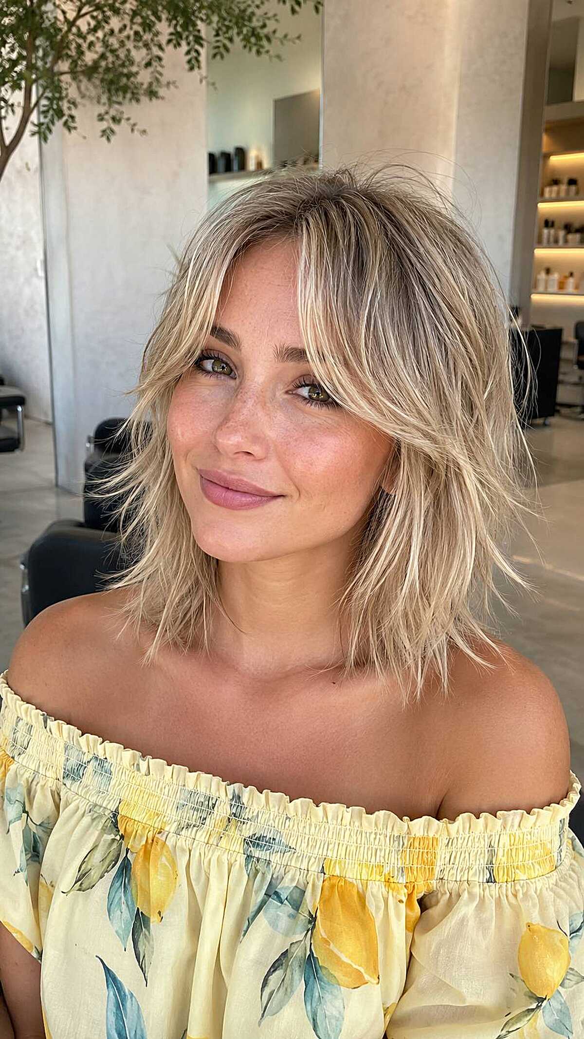 Blonde textured bob shag with dark roots and bangs