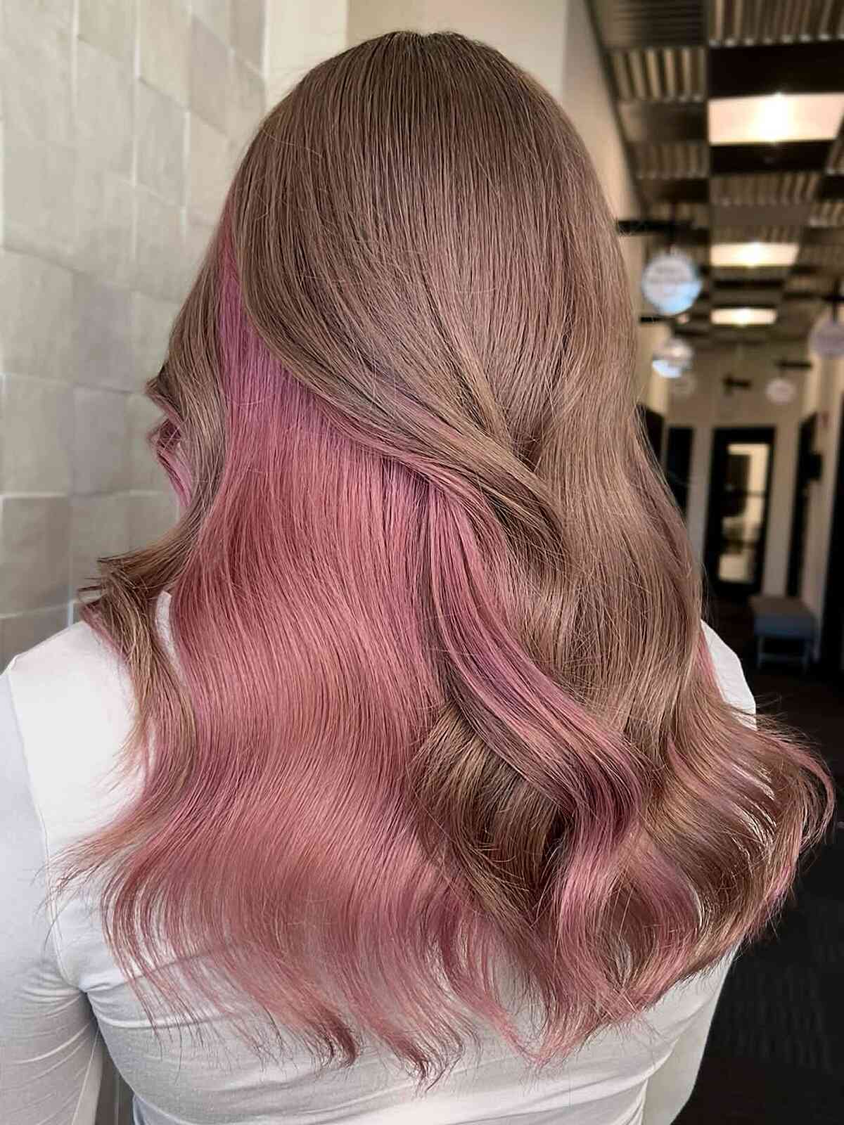 Soft Rose Peekaboo Highlights on Long Wavy Hair