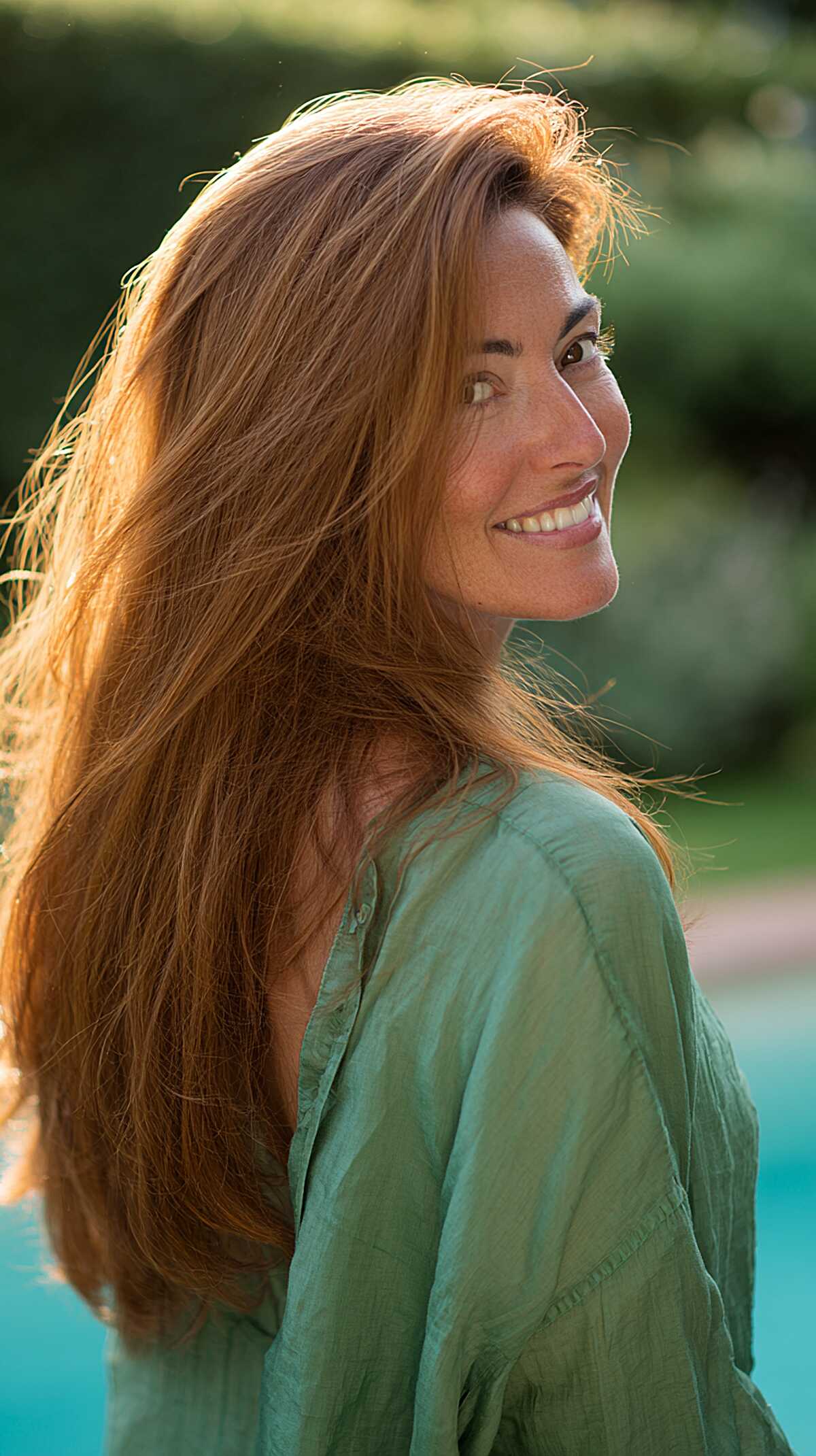Long golden copper hair with natural volume in sunlight