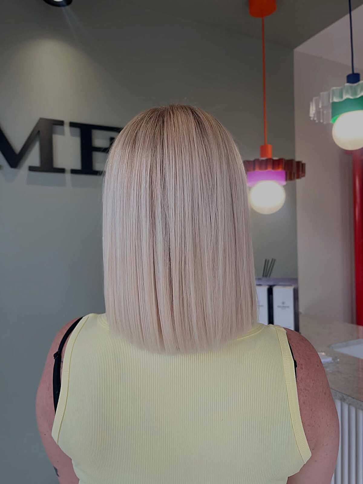 Blunt one-length bob in pale blushed porcelain blonde
