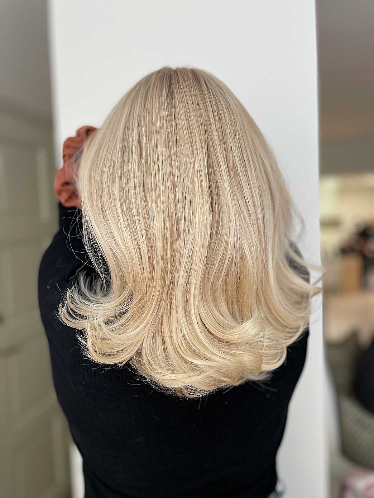 Medium champagne blonde with bouncy flipped-out ends