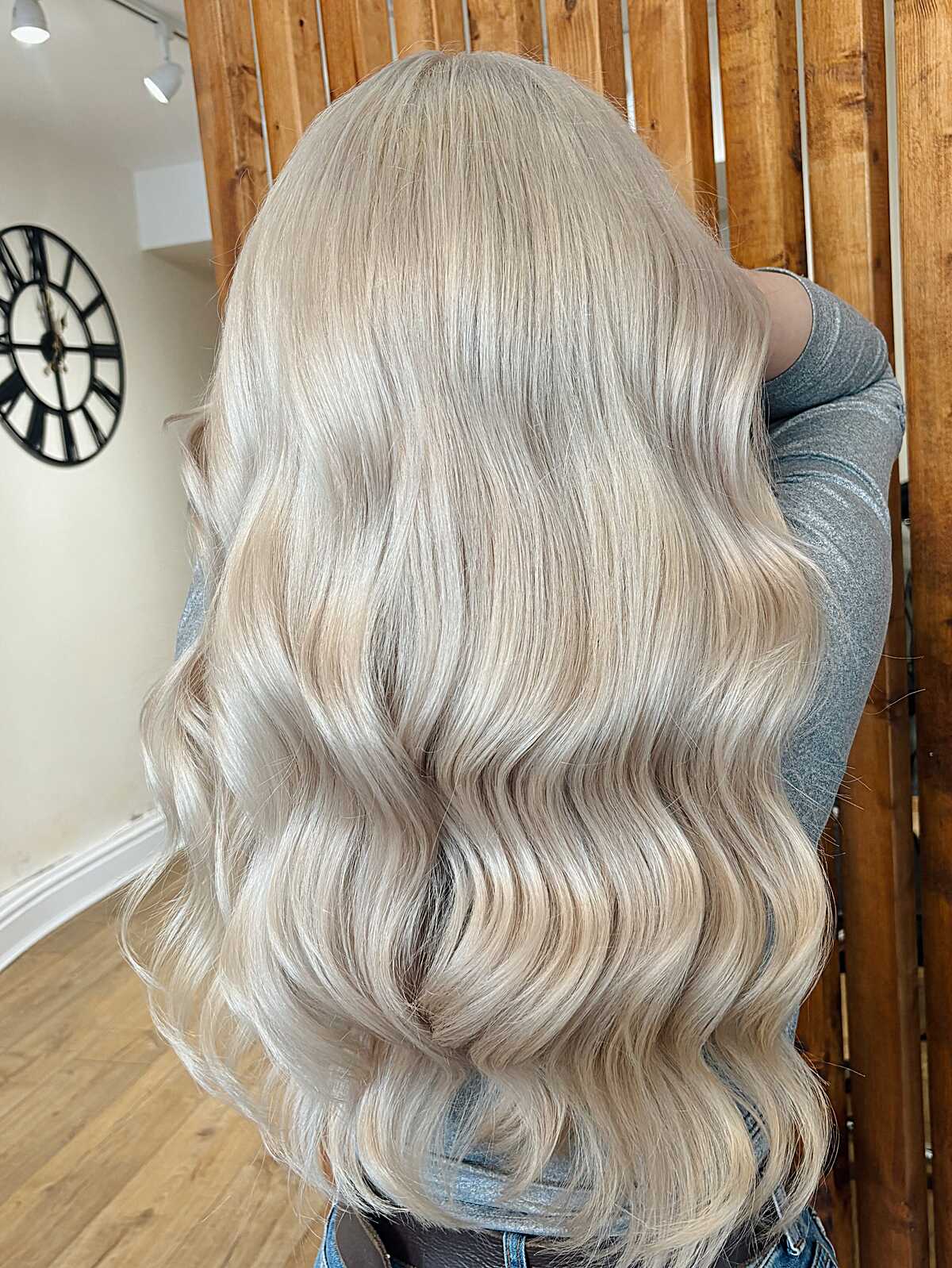 Long creamy platinum blonde waves with seamless root blend