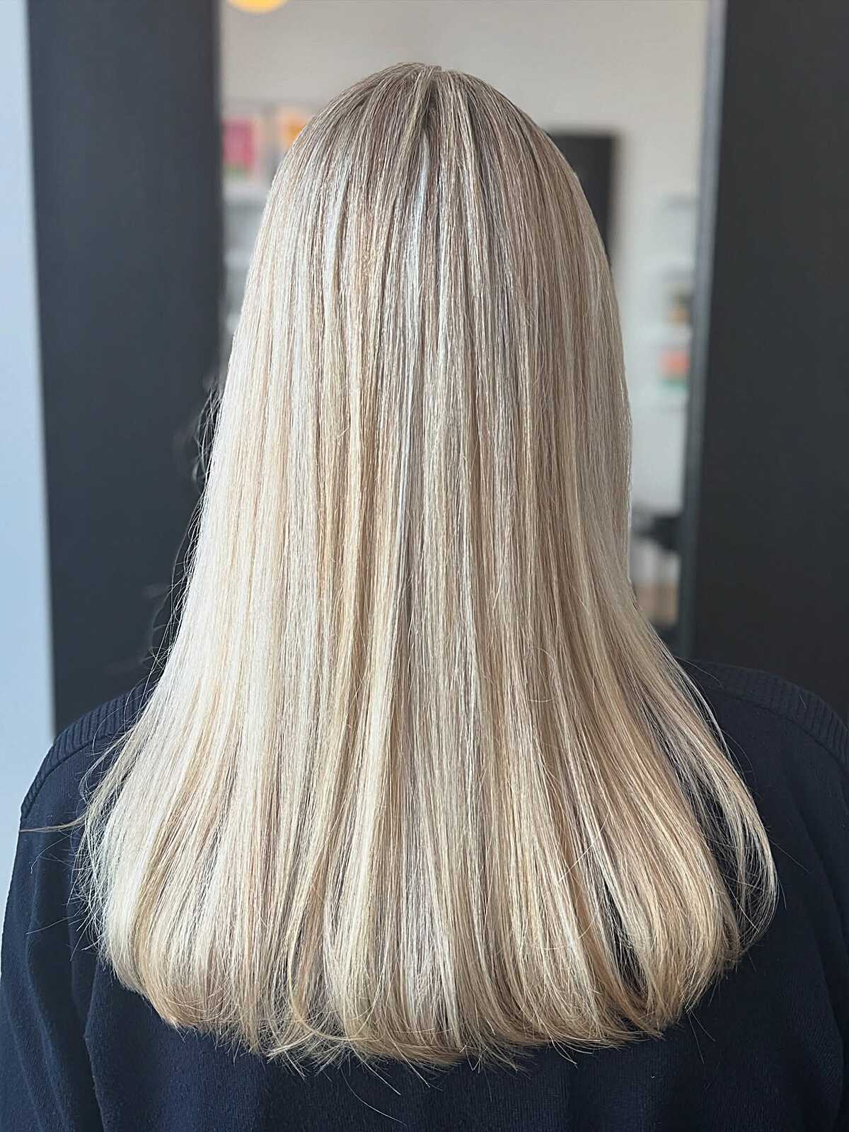 Long straight sandy blonde hair with subtle highlights