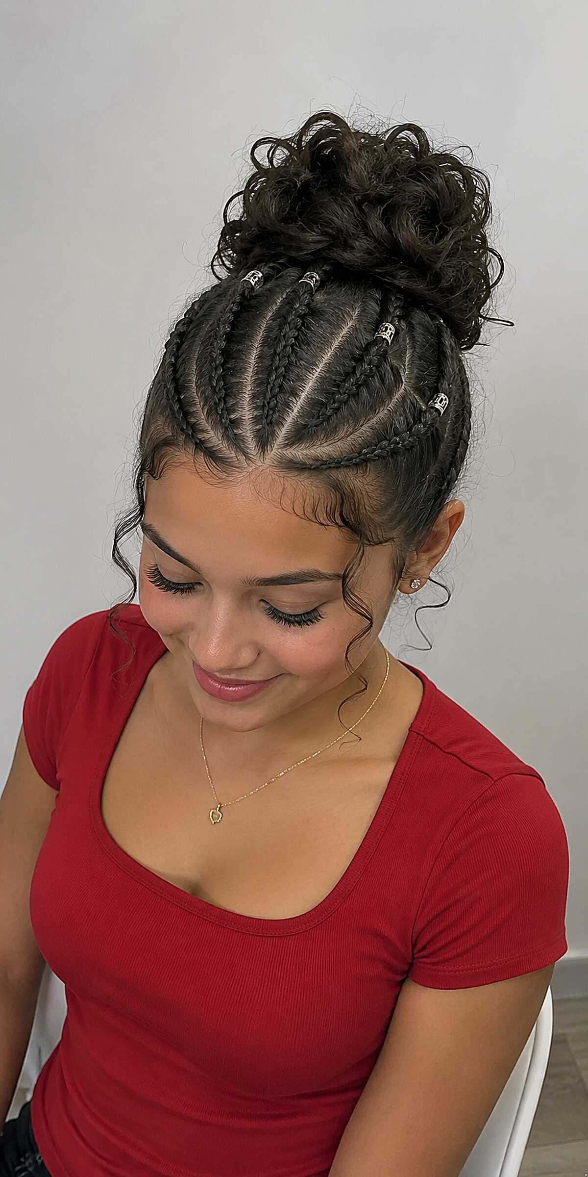 Cornrow Updo with Curly Bun and Silver Cuffs