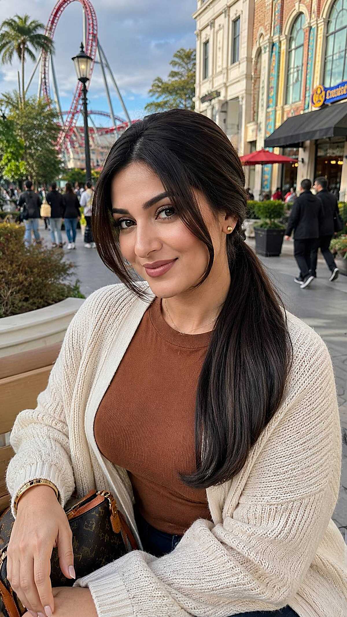 Long dark sleek hair with a deep side part at a theme park