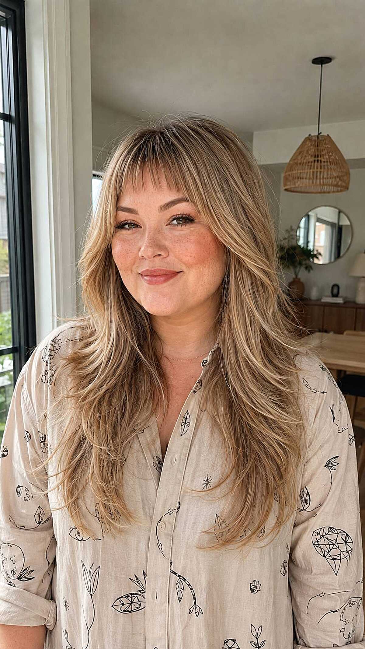 Long blonde layered hair with wispy feathered bangs