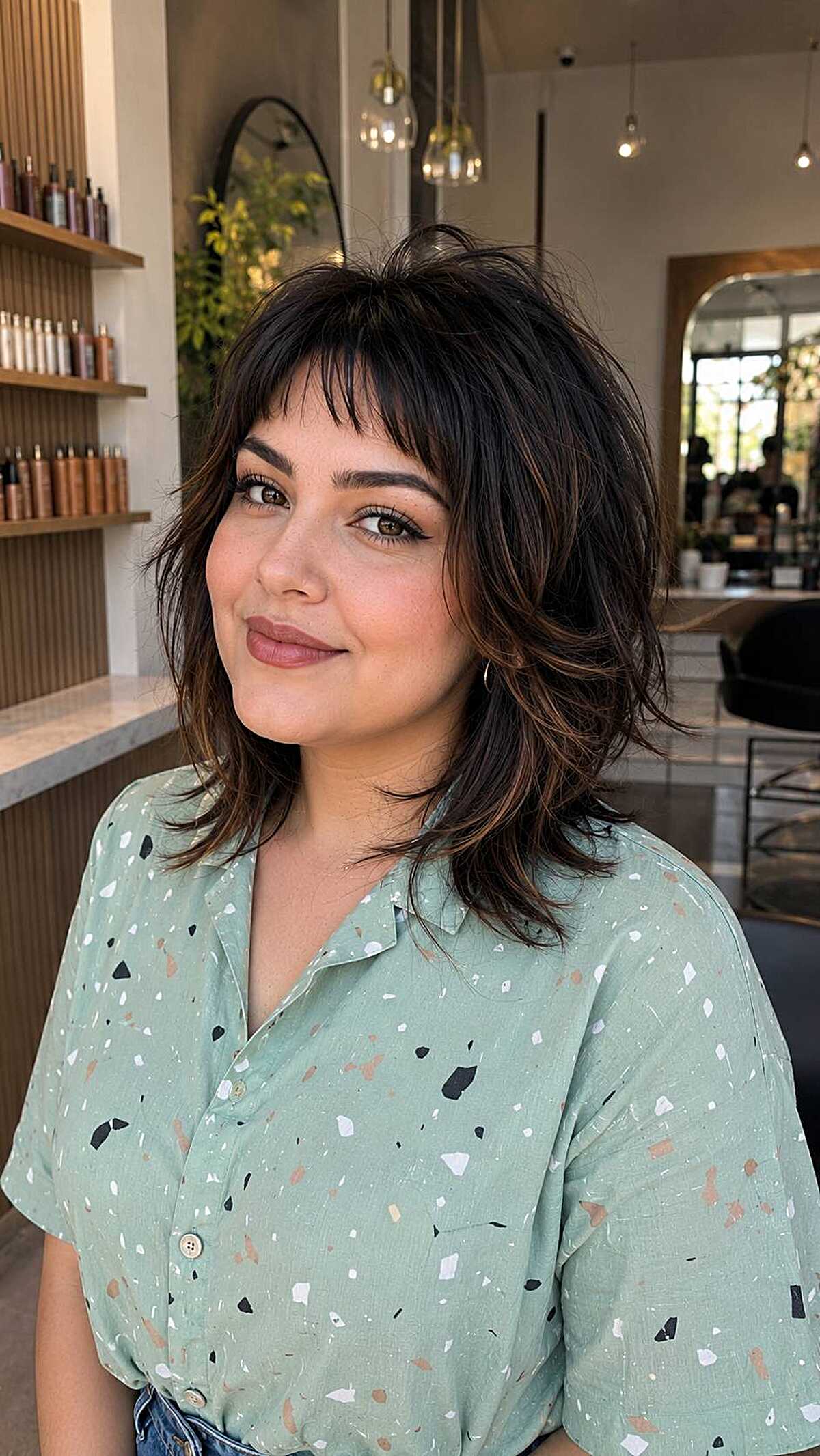 Dark shoulder-length shag with thin wispy baby bangs