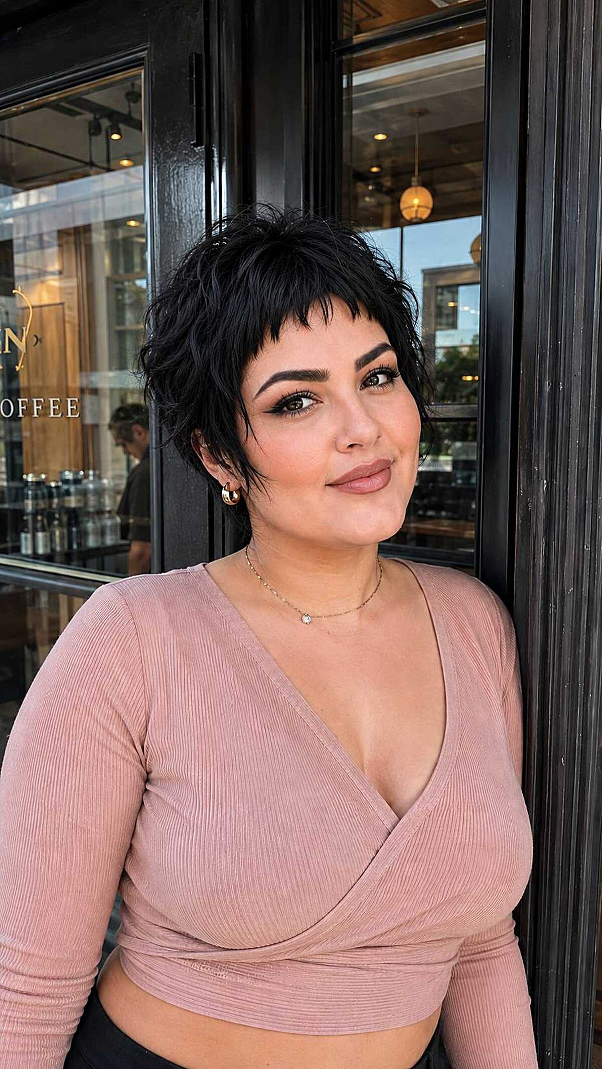 Black textured pixie cut with short choppy bangs