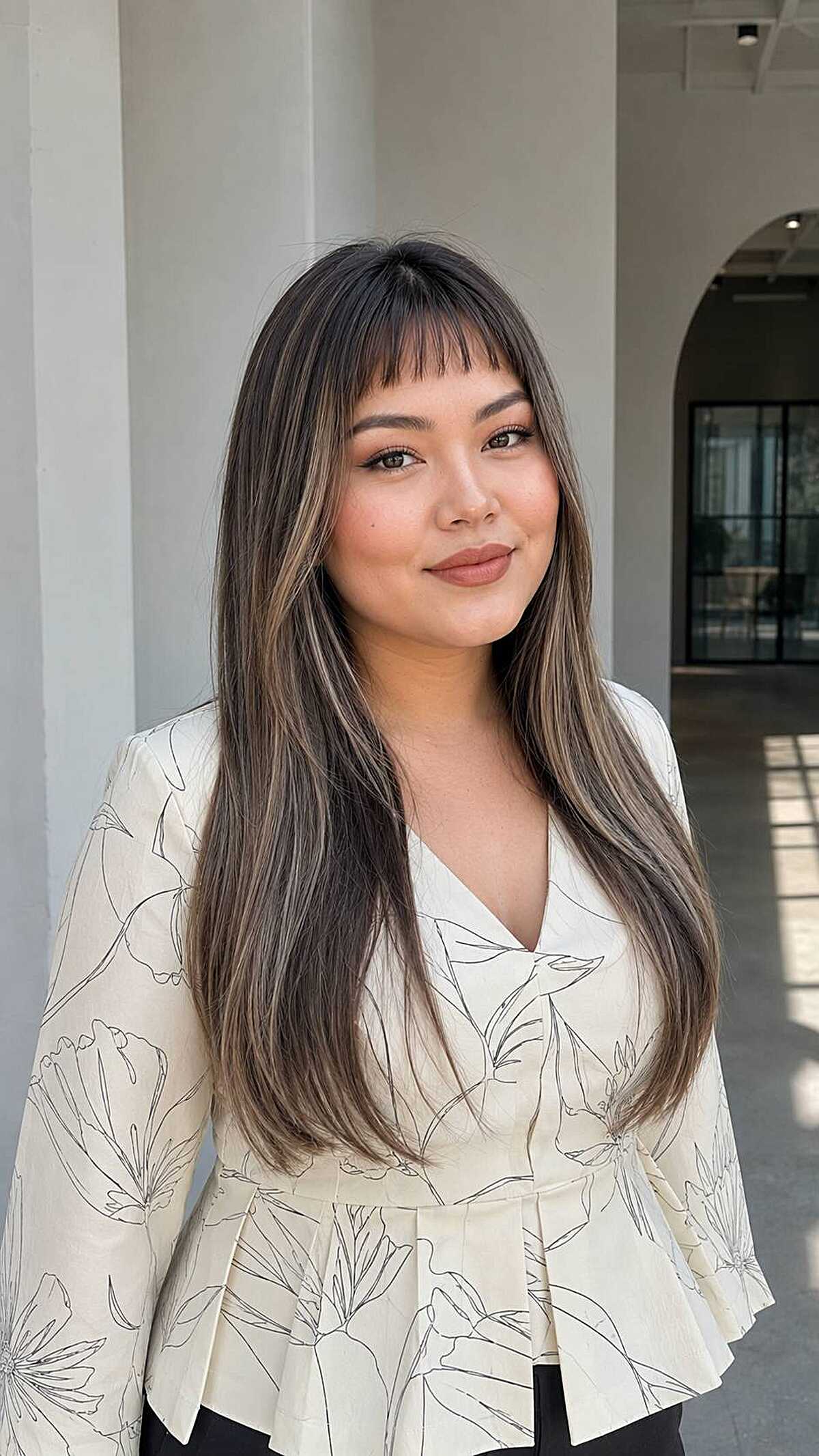 Long straight dark hair with thin baby bangs above brows