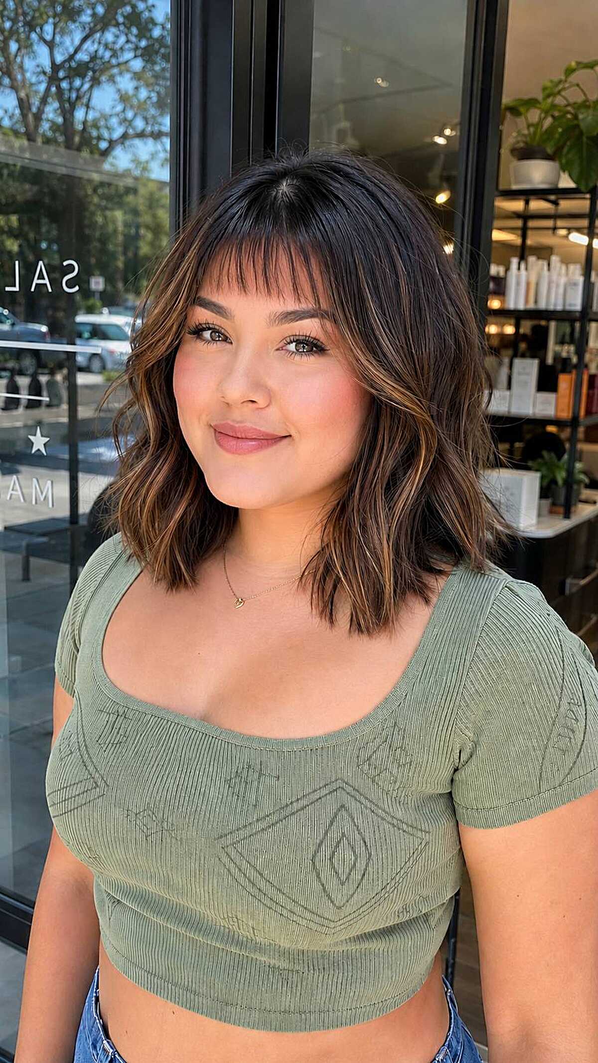 Brunette lob with caramel highlights and piecey bangs