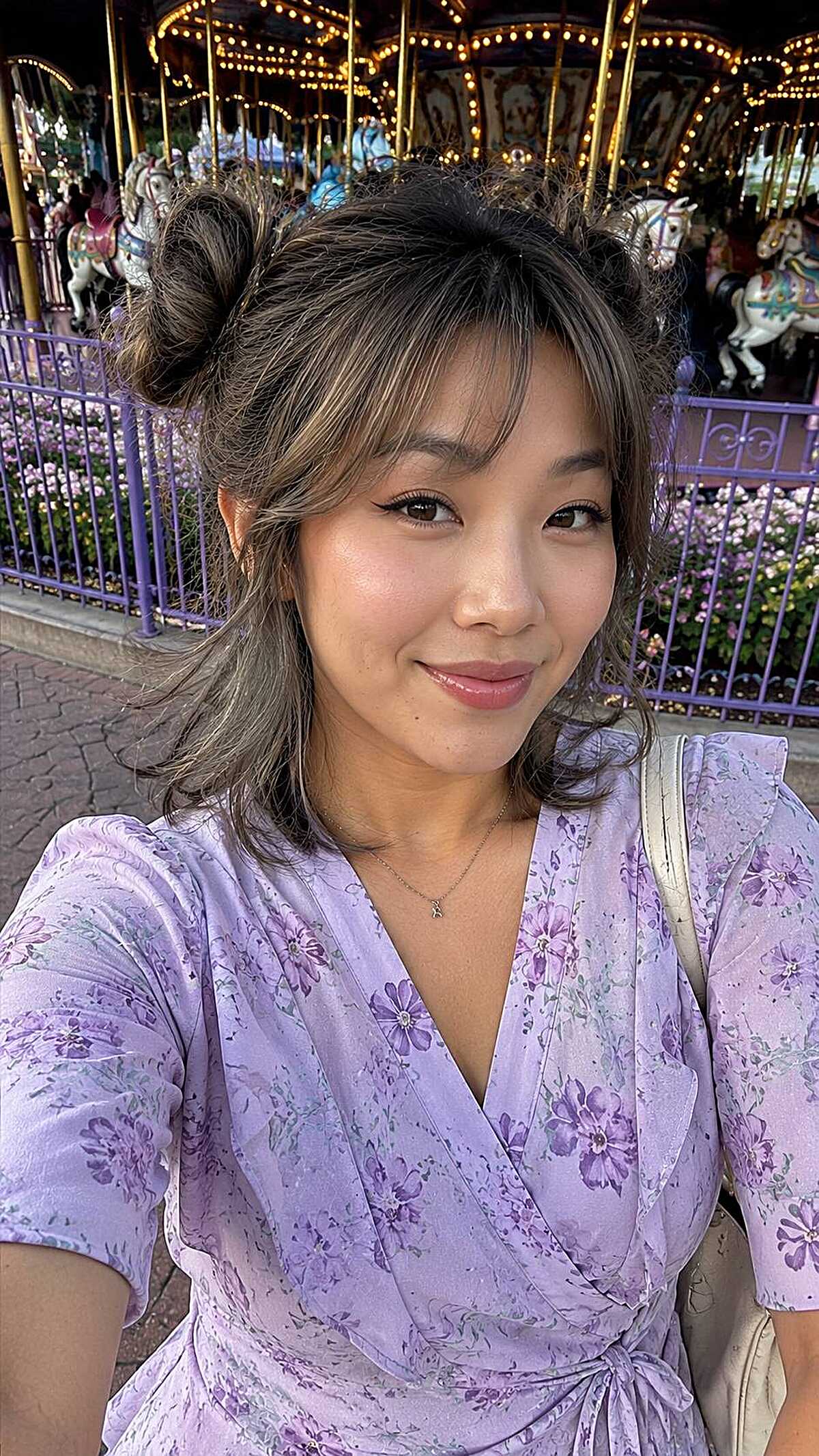 Two small space buns with wispy bangs at carousel