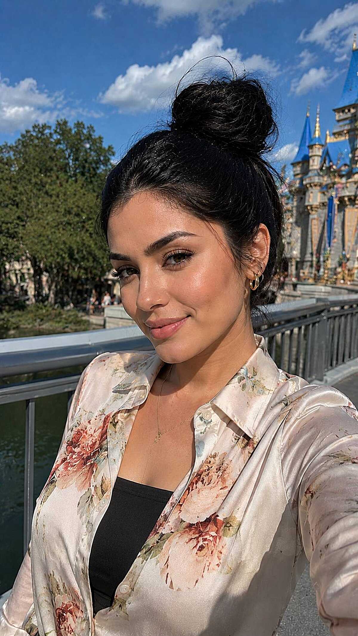Messy high bun with jet black hair at Disney castle