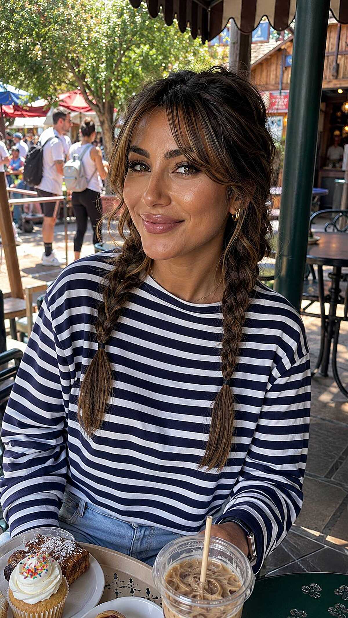 Relaxed pigtail braids with bangs at theme park cafe