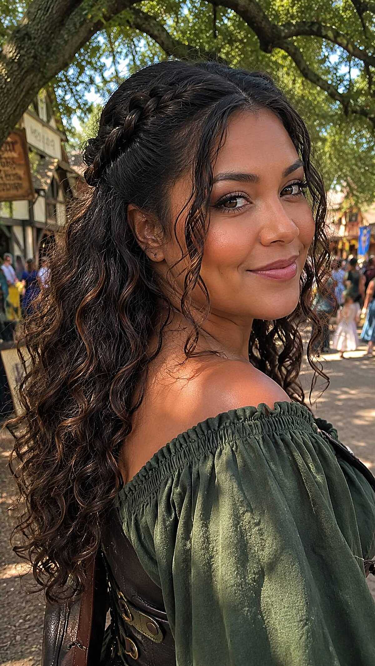 Curly dark hair with braided crown half-up style