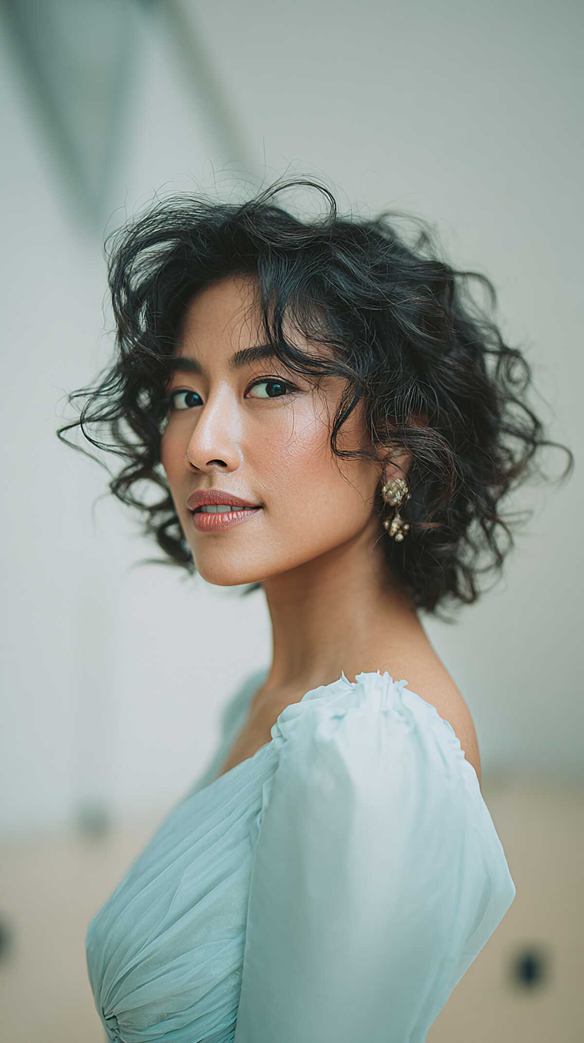 Chin-Length Curly Bob Left Loose with Soft Curtain Fringe