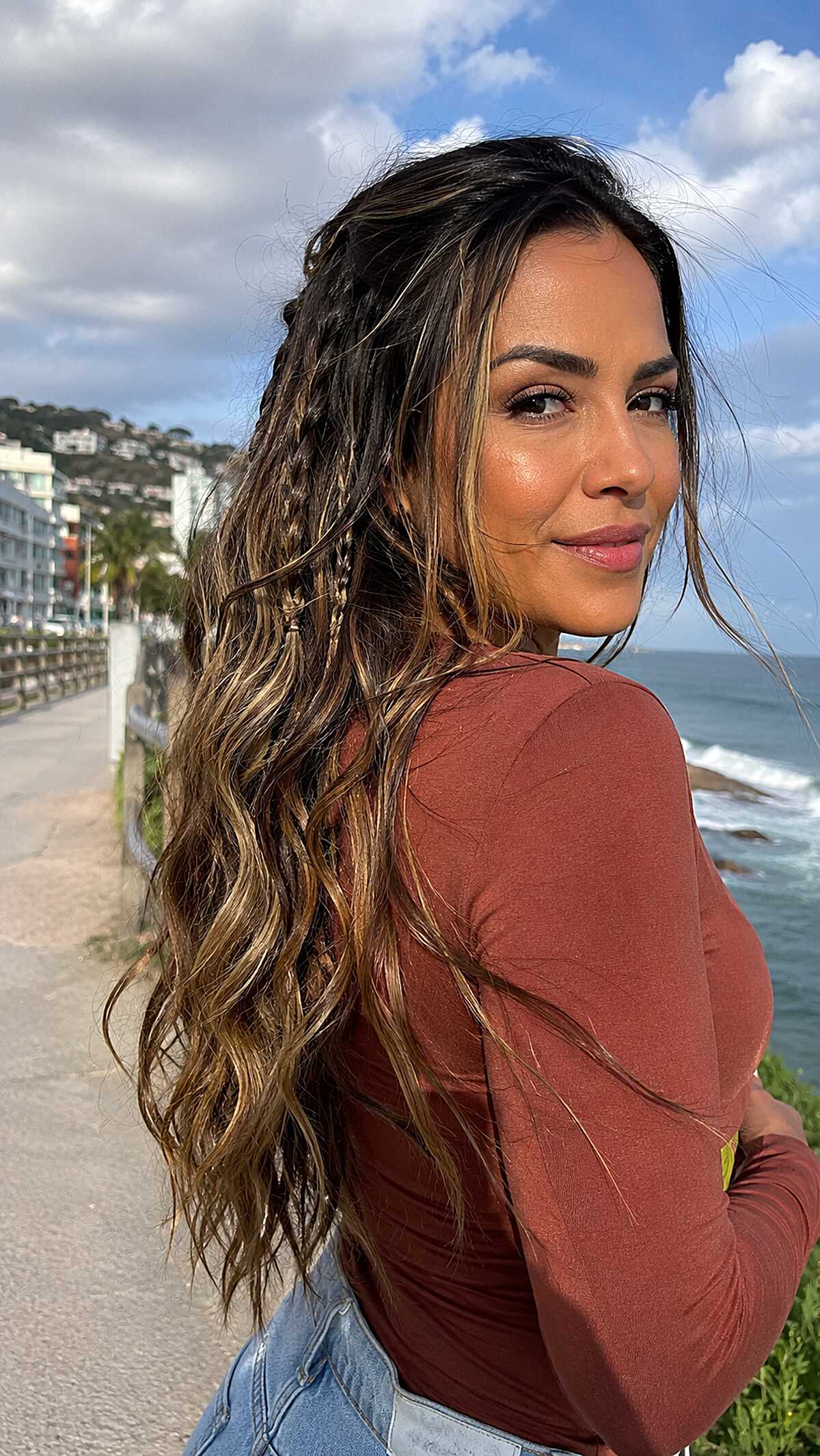 Hidden Three-Strand Braids Woven into Long Dark Waves with Honey Balayage
